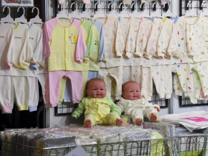 his picture taken on December 21, 2017 shows baby clothes displayed on a booth at a baby fair in Seoul. Rapid economic growth over several decades has seen South Korea's GDP boom, but birth rates have gone in the opposite direction. The country's fertility rate -- an average number of …