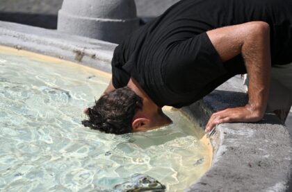 A man cools off at a fountain in Rome as Europe braces for new high temperatures