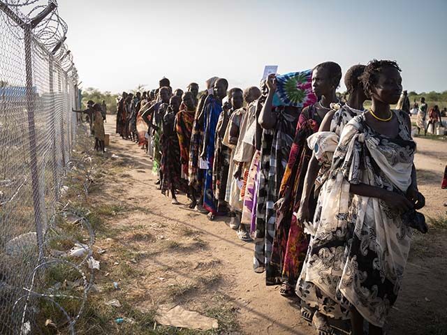 Women from Murle ethnic group wait in a line for a food distribution by United Nations World Food Programme (WFP) in Gumuruk, South Sudan, on June 10, 2021, as their village where recently attacked by armed youth group. - An escalation in conflict has led to the displacement of thousands …