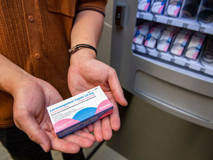 A person holds a carton of the "morning-after" pill purchased from the Plan-B vending machine that sits in the basement of the student union building on the Boston University Campus in Boston, Massachusetts on July 26, 2022. - Each carton contains a single pill and cost $7.25 US and is …