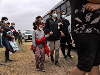 LA JOYA, TEXAS - APRIL 13: Unaccompanied minors board a U.S. Customs and Border Protection bus to an immigrant processing center after crossing the border from Mexico on April 13, 2021 in La Joya, Texas. A surge of immigrants crossing into the United States, including record numbers of children, has …