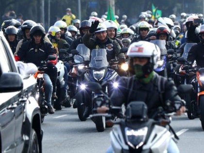 SAO PAULO, BRAZIL - JUNE 12: President of Brazil Jair Bolsonaro (C) rides a motorcycle along with supporters during a motorcycle rally through the streets of Sao Paulo on June 12, 2021 in Sao Paulo, Brazil. (Photo by Rodrigo Paiva/Getty Images)