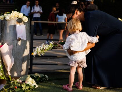 ANNECY, FRANCE - JUNE 08: A woman and her daughter lay flowers at the children's park in Paquier park, where a knife attack took place, on June 8, 2023 in Annecy, France. Several people, including four young children, were injured in a knife attack in a playground in the southeastern …