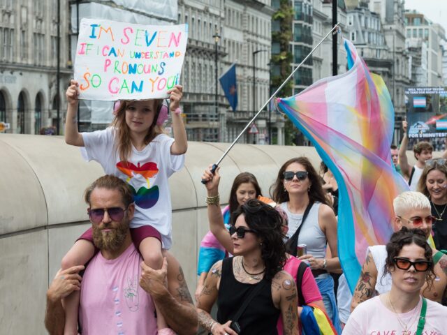 LONDON, UNITED KINGDOM - JULY 08, 2023: A girl holds a placard reading 'I'm seven, if I can understand pronouns so can you' as transgender people and their supporters march through central London during the fifth Trans Pride protest march for transgender freedom and equality in the UK and globally …