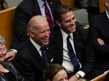 From right, Tom Daschle, Hunter Biden, Vice President Joe Biden, and daughters of George McGovern Ann McGovern and Susan Rowen, laugh as they listen to Matt McGovern, grand son of George McGovern, at a prayer service for the former Democratic U.S. senator and three-time presidential candidate George McGovern at the …