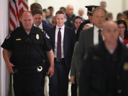 Mark Zuckerberg surrounded by guards
