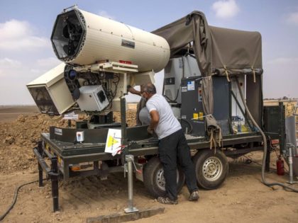 An Israeli police officer demonstrates a laser defense system designed to intercept explosives-laden balloons launched from the Gaza Strip into Israel, on the Israeli Gaza border, Aug. 30, 2020.A new Israeli laser missile defense system has successfully intercepted mortars, rockets and anti-tank missiles in recent tests, Defense Minister Benny Gantz …