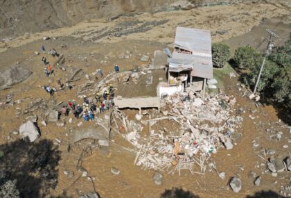 Rescue teams with drones search for landslide survivors