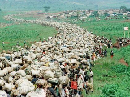 FILE - Tens of thousands of Rwandan refugees, who have been forced by Tanzanian authorities to return to their country despite fears they will be killed upon their return, stream back towards the Rwandan border on a road in Tanzania, on Dec. 19, 1996. A frail 87-year-old Rwandan, Félicien Kabuga, …