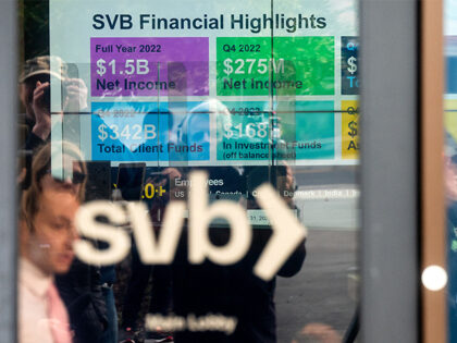 A display lists Silicon Valley Bank (SVB) achievements as customers gather to withdraw money at SVBs headquarters in Santa Clara, California, on March 13, 2023. (NOAH BERGER/AFP via Getty Images)