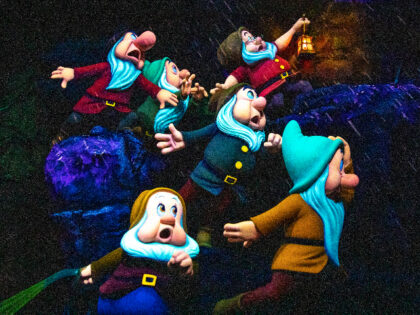 Anaheim, CA - May 03:The seven Dwarfs caught in a rain storm as darkness descends on Snow Whites Enchanted Wish ride at the Disneyland Resort in Anaheim, CA, as visitors return to the park with covid-safety restrictions in place, including masks and the park only being at 25% capacity, photographed …