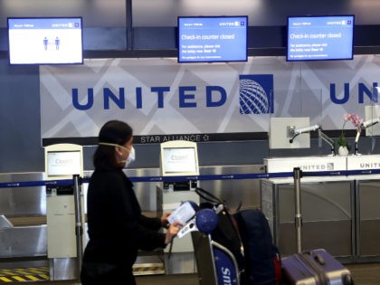 A United Airlines passenger pushes a luggage cart past closed check-in kiosks at San Francisco International Airport on July 08, 2020 in San Francisco, California. As the coronavirus COVID-19 pandemic continues, United Airlines has sent layoff warnings to 36,000 of its front line employees to give them a 60 day …