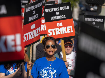 LOS ANGELES, CA - MAY 02: People picket outside of Paramount Pictures on the first day of the Hollywood writers strike on May 2, 2023 in Los Angeles. Scripted TV series, late-night talk shows, film and streaming productions are being interrupted by the Writers Guild of America (WGA) strike. In …